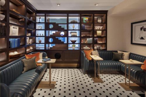 a waiting room with couches and bookshelves at The Algonquin Hotel Times Square, Autograph Collection in New York