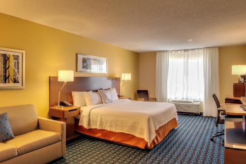 a hotel room with a bed and a couch at Fairfield Inn by Marriott Las Cruces in Las Cruces