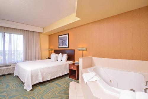 a hotel room with a bed and a bathtub at SpringHill Suites Arundel Mills BWI Airport in Hanover