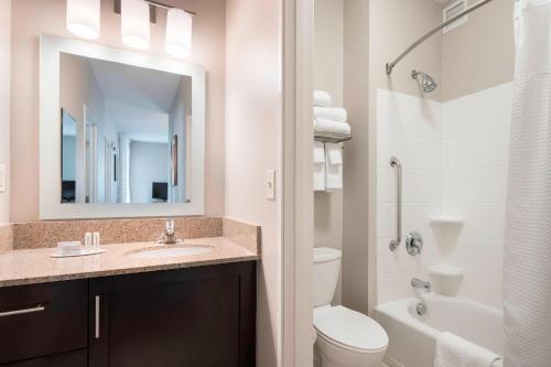a bathroom with a sink and a toilet and a mirror at TownePlace Suites by Marriott San Diego Carlsbad / Vista in Vista