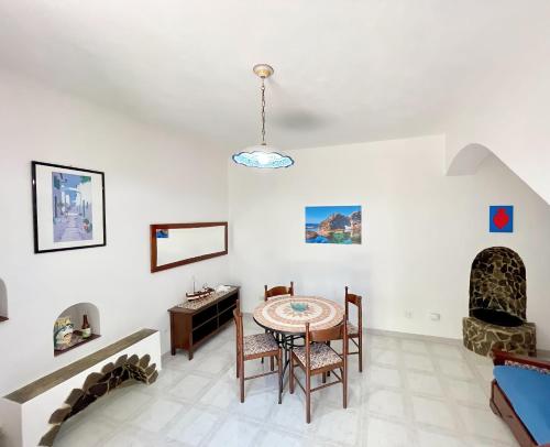 a dining room with a table and chairs at Aeolian Apartments in Lipari
