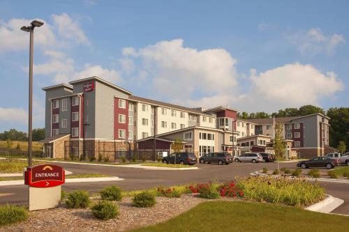 a building with a sign in front of a parking lot at Residence Inn by Marriott Grand Rapids Airport in Grand Rapids
