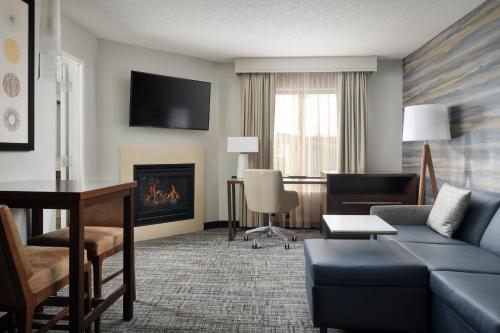a living room with a couch and a fireplace at Residence Inn by Marriott Grand Rapids Airport in Grand Rapids