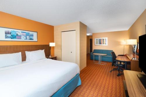 a hotel room with a bed and a desk at Fairfield Inn and Suites by Marriott Nashville Smyrna in Smyrna