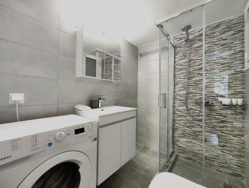 a bathroom with a washing machine and a shower at Dimitsanas by Verde Apartments in Athens