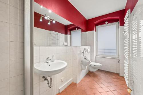 a bathroom with a sink and a toilet at Budget Apartment am Fernsehturm in Berlin