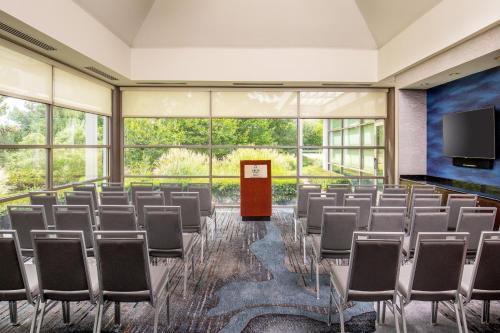 a conference room with chairs and a flat screen tv at Delta Hotels by Marriott Chesapeake Norfolk in Chesapeake