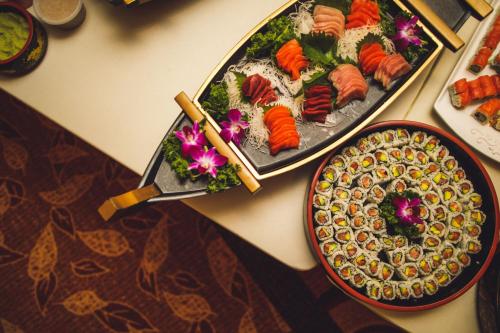 a table with two plates of sushi and a pizza at Bridgewater Marriott in Bridgewater