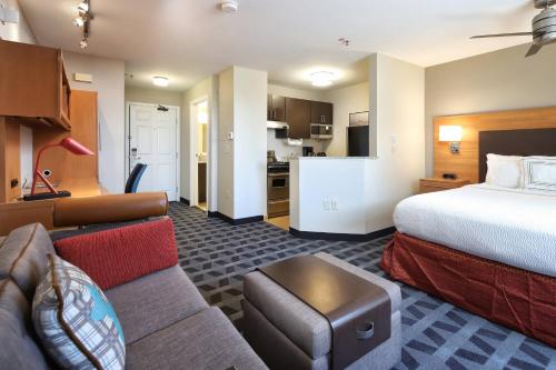 ツーソンにあるTownePlace Suites Tucsonのベッドとソファ付きのホテルルーム