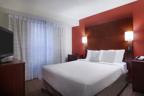a hotel room with a bed and a flat screen tv at Residence Inn by Marriott San Antonio Downtown Market Square in San Antonio