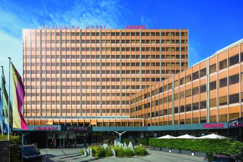 a large building with a sign on top of it at Mövenpick Hotel Geneva in Geneva