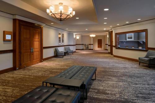 a lobby with a waiting room with benches in it at Newport News Marriott at City Center in Newport News
