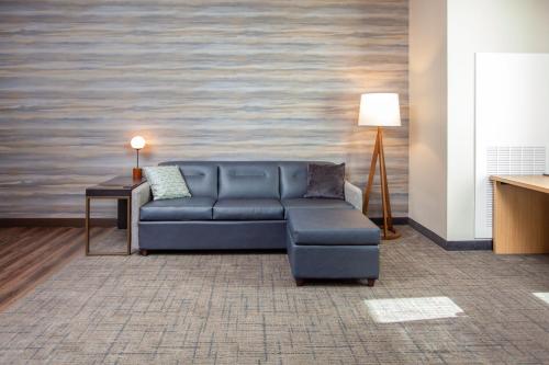 a living room with a blue couch and a table at Residence Inn Livermore in Livermore