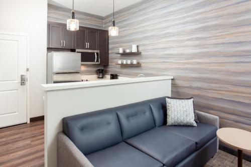 a living room with a couch and a kitchen at Residence Inn Livermore in Livermore
