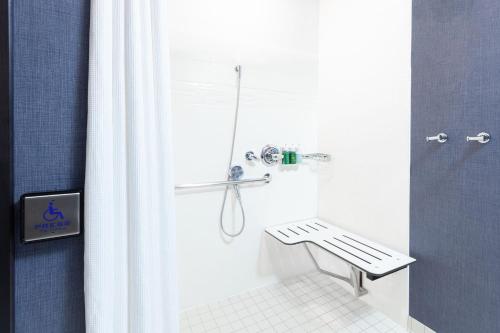 a bathroom with a shower with a bench in it at Residence Inn Livermore in Livermore