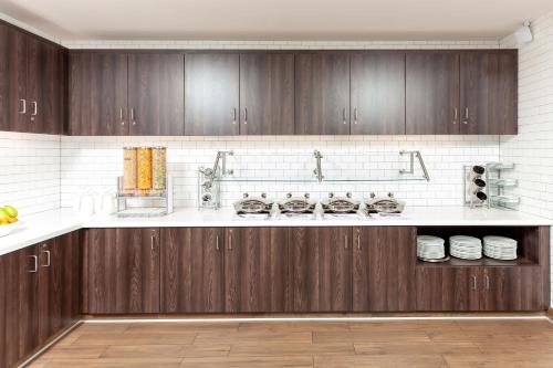a kitchen with wooden cabinets and white counter tops at Residence Inn Livermore in Livermore