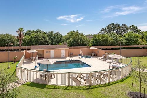 a swimming pool with a fence around it at Courtyard by Marriott Bryan College Station in College Station