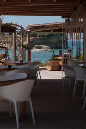 a group of tables and chairs on a patio at Del Mare Beach Hotel in Sidari
