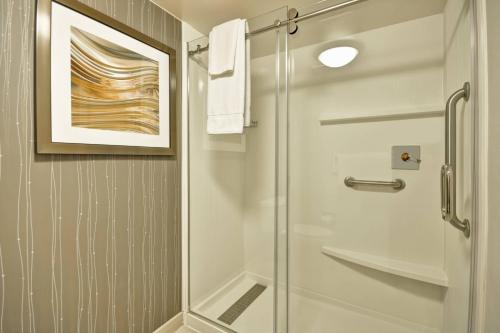 a shower with a glass door in a bathroom at Courtyard by Marriott Jacksonville Airport/ Northeast in Jacksonville