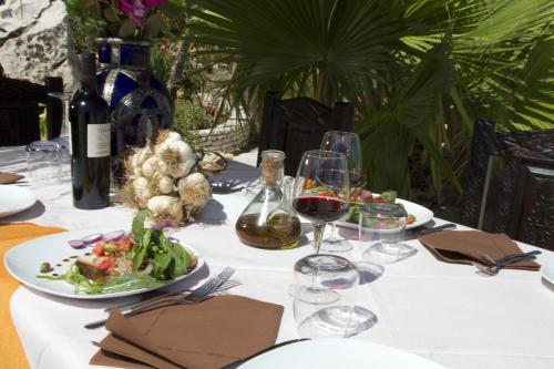 a table with wine glasses and a plate of food at Hotel Scialì in Vieste