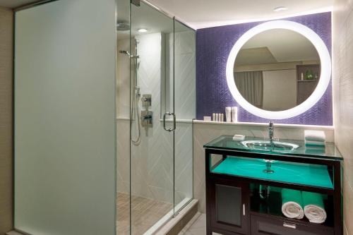 a bathroom with a sink and a shower with a mirror at Fairfield Inn by Marriott Montreal Downtown in Montreal