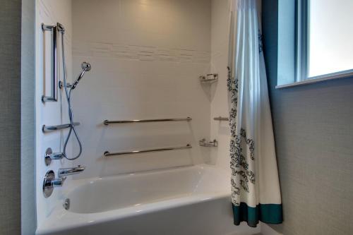 a white bathroom with a shower and a tub at Residence Inn by Marriott Philadelphia Valley Forge/Collegeville in Collegeville