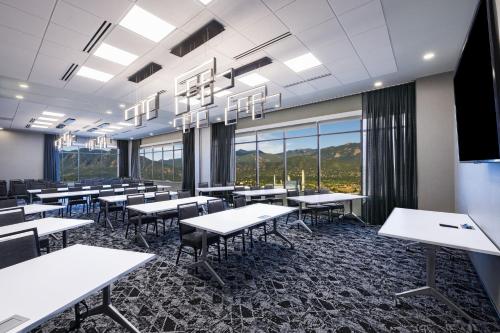 a classroom with tables and chairs and windows at Element Colorado Springs Downtown in Colorado Springs