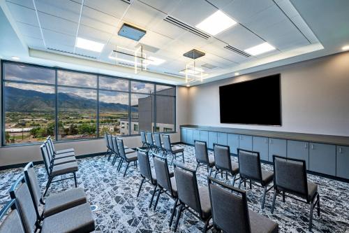 a conference room with chairs and a flat screen tv at Element Colorado Springs Downtown in Colorado Springs
