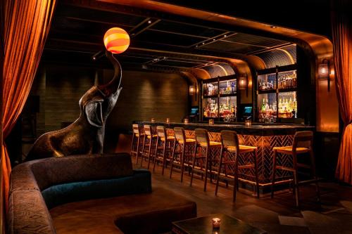 a bar with an elephant statue in a room at MOXY NYC Times Square in New York