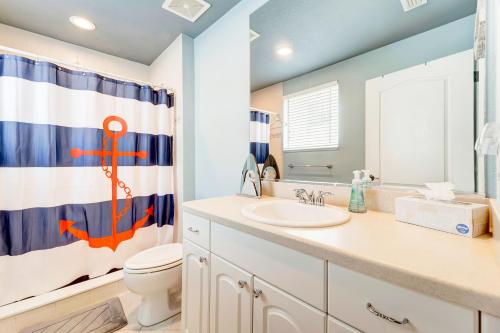 a bathroom with a sink and an anchor shower curtain at Waterfront Boater's Paradise in Englewood