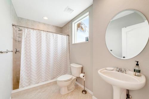 a bathroom with a toilet and a sink and a mirror at Waterfront Boater's Paradise in Englewood