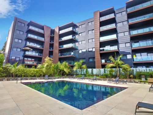 a swimming pool in front of a building at Lynx Barreiros by LovelyStay in Funchal