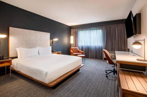 a hotel room with a bed and a desk at Courtyard Orlando Altamonte Springs Maitland in Orlando