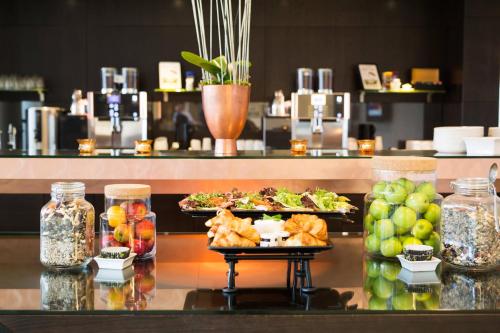 a buffet with plates of food on a table at Courtyard by Marriott Stockholm Kungsholmen in Stockholm
