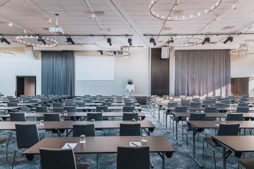 a classroom with tables and chairs in a room at Courtyard by Marriott Stockholm Kungsholmen in Stockholm