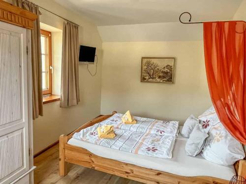 1 cama en un dormitorio con cortina roja en Ferienwohnungen Am Eifelsteig, en Neroth