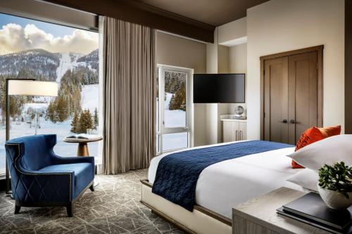 a hotel room with a bed and a large window at The Josie Hotel, Autograph Collection in Rossland