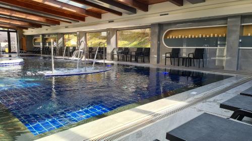 a swimming pool with a fountain in a building at Studio with balcony, mountain view, 4* SPA Resort, Bansko in Bansko