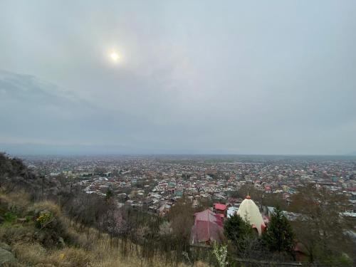 a view of a city with the moon in the sky at HOTEL ROYAL HAMEED in Srinagar