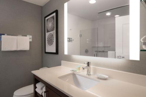 a bathroom with a sink and a mirror at Residence Inn by Marriott Texarkana in Texarkana