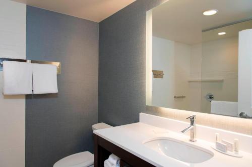 a bathroom with a sink and a mirror at Residence Inn by Marriott Houston City Place in Spring