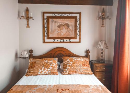 sypialnia z łóżkiem z obrazem na ścianie w obiekcie Apartamentos en pleno centro, Aljibe Rodrigo del Campo 2C w Grenadzie