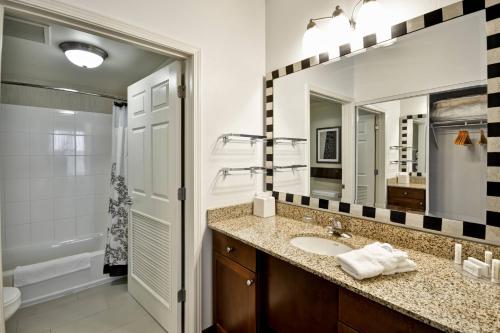 a bathroom with a sink and a mirror at Residence Inn Saint Louis O'Fallon in O'Fallon