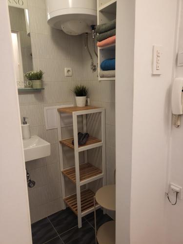 a small bathroom with a toilet and a sink at Studio 12 in Zagreb