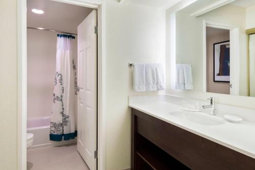 a bathroom with a sink and a shower at Residence Inn by Marriott Fort Myers in Fort Myers