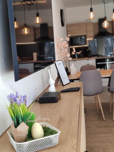 a wooden table with a counter top with flowers on it at Room in the city 2 in Sopron