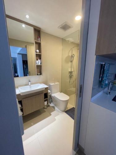 a bathroom with a sink and a toilet and a mirror at Laguna SkyPark вид на горы и озера три 25 метровых бассейна на крыше, 500 Мбит интернет, все апартаменты верхние 6 и 7 этажи in Bang Tao Beach