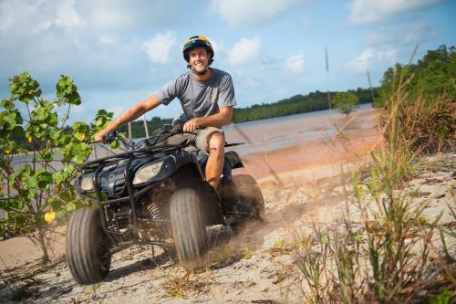 a man riding an atv on the beach at Natra Bintan, a Tribute Portfolio Resort in Lagoi