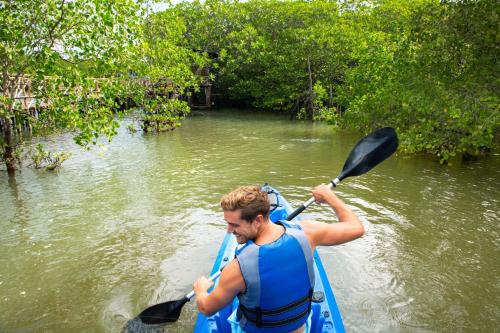 a man is in a kayak in the water at Natra Bintan, a Tribute Portfolio Resort in Lagoi