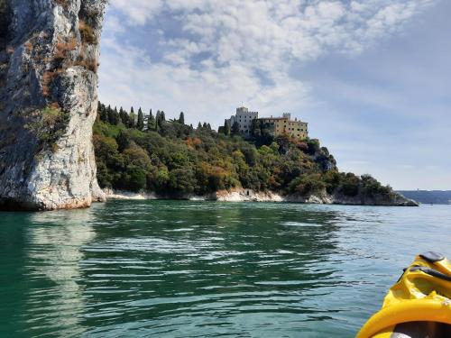 a view of a castle on an island in the water at Agriturismo Ai Tre Sentieri in Aurisina